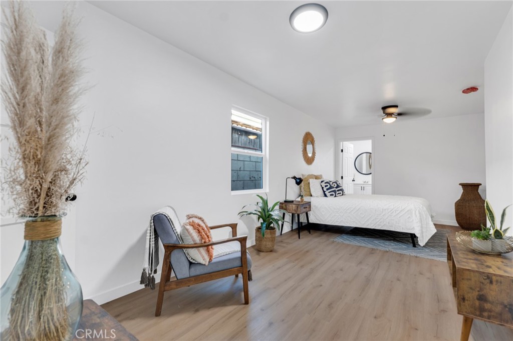 2124 East Oris Street Compton, CA 90222 - Photo 7 of 20 a bedroom with furniture and a wooden floor