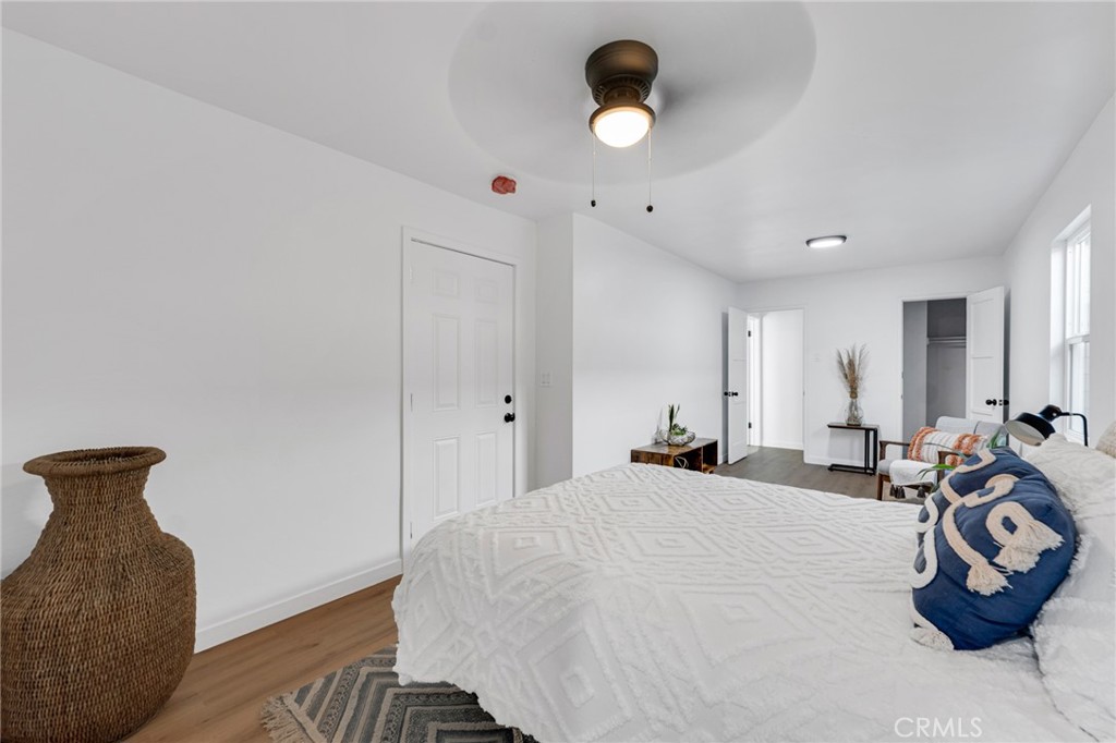 2124 East Oris Street Compton, CA 90222 - Photo 8 of 20 a bedroom with a bed and a chandelier