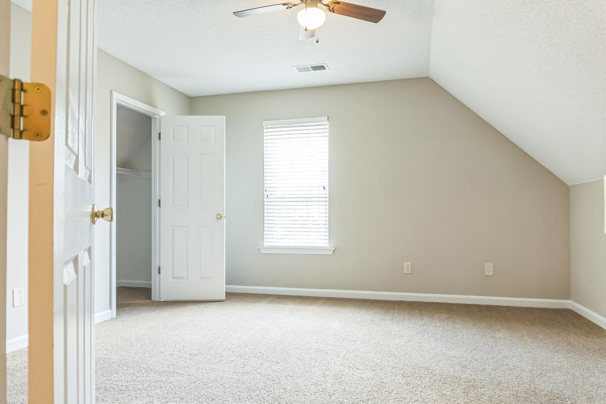 5368 Milton Ridge Drive Arlington, TN 38002 - Photo 11 of 15 Interior space featuring baseboards, carpet flooring, a ceiling fan, visible vents, and lofted ceiling