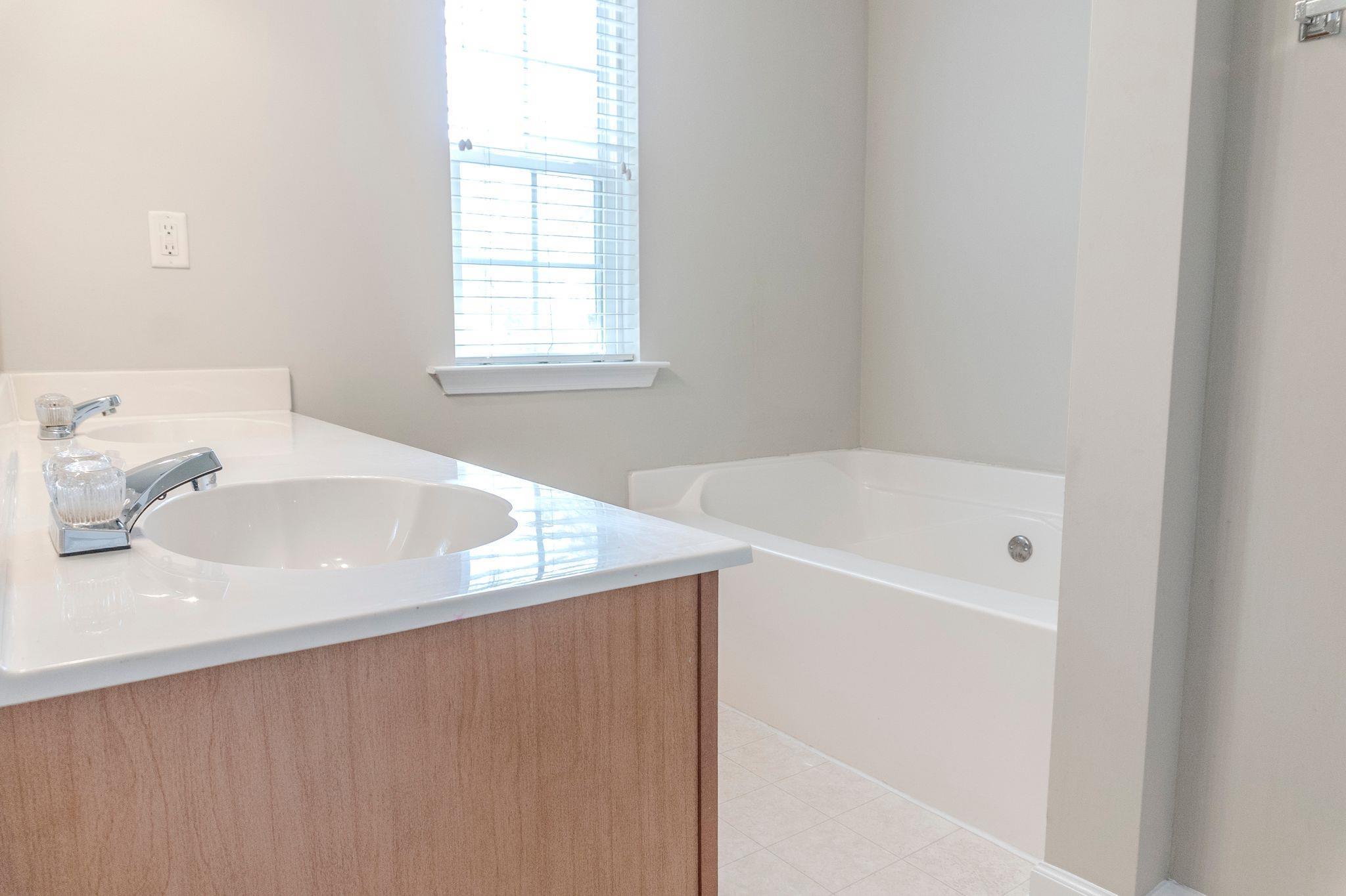 5368 Milton Ridge Drive Arlington, TN 38002 - Photo 14 of 15 Full bathroom featuring double vanity, a garden tub, and a sink