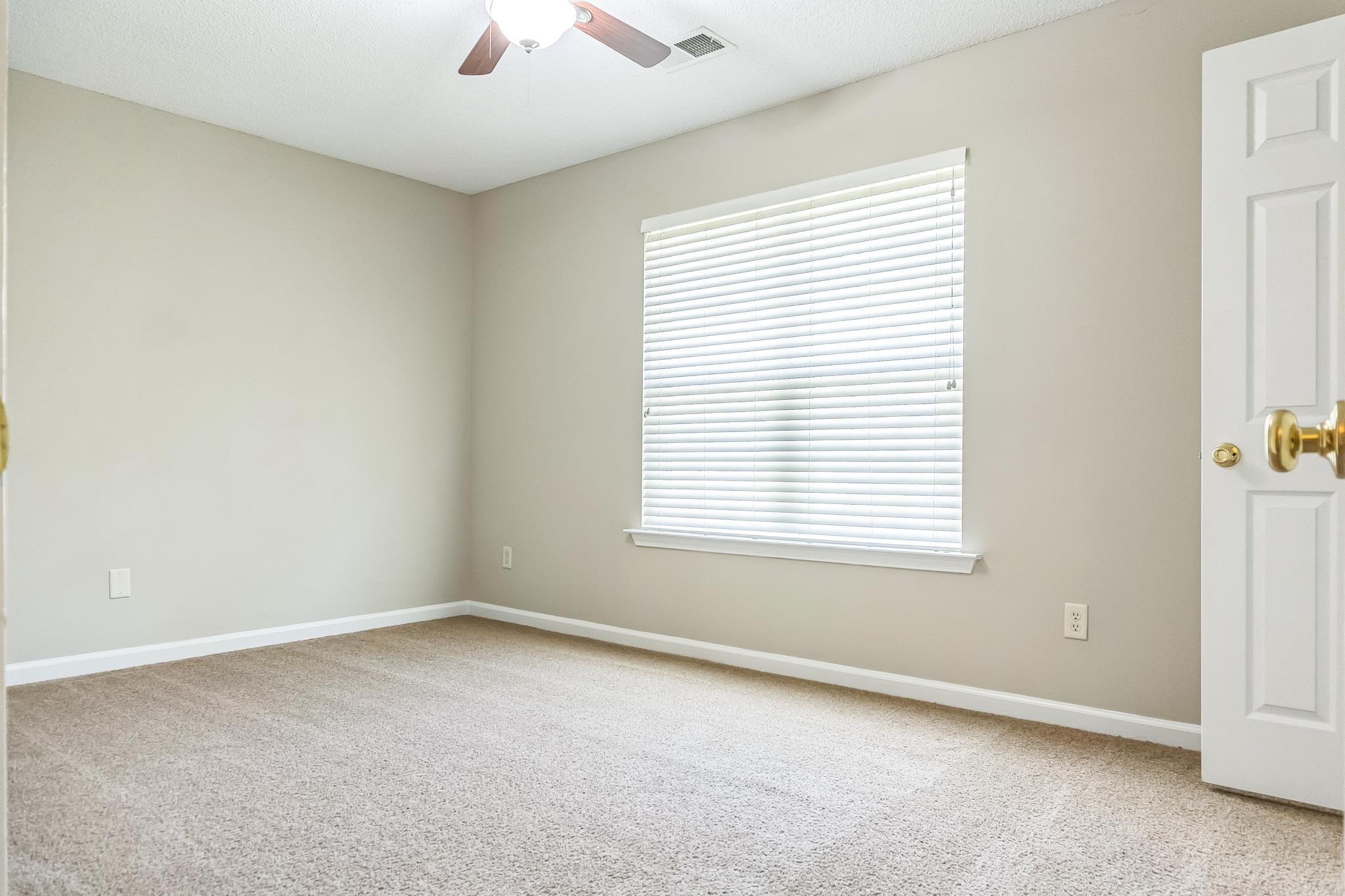 5368 Milton Ridge Drive Arlington, TN 38002 - Photo 8 of 15 Spare room with light carpet, visible vents, baseboards, and a ceiling fan