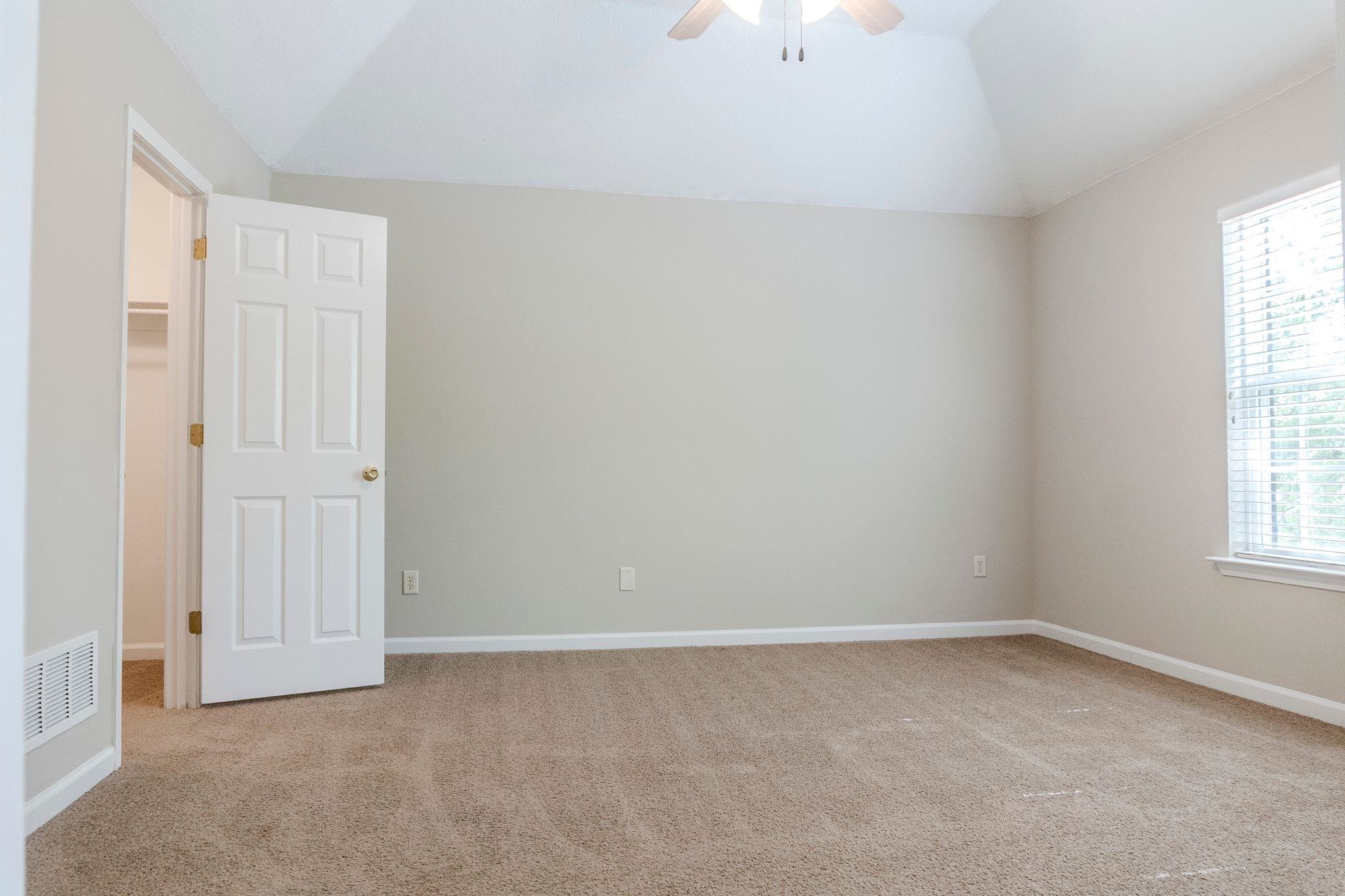 5368 Milton Ridge Drive Arlington, TN 38002 - Photo 10 of 15 Carpeted empty room featuring vaulted ceiling, visible vents, baseboards, and ceiling fan