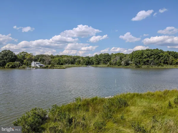 an aerial view of a house with a yard and lake view