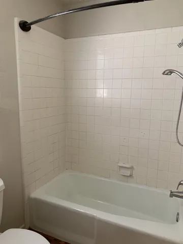 a bathroom with a bathtub and a shower