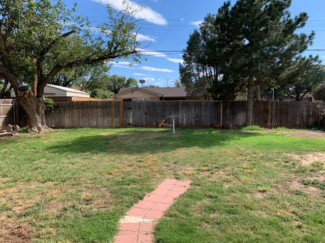a view of a backyard with a small cabin