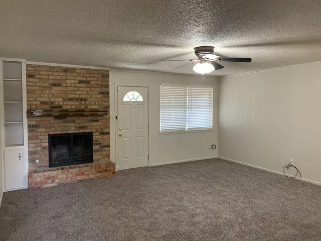 a view of empty room with a fireplace