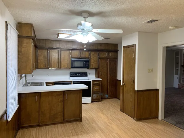a kitchen with stainless steel appliances a sink stove and refrigerator