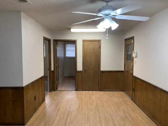 a view of a room with wooden floor
