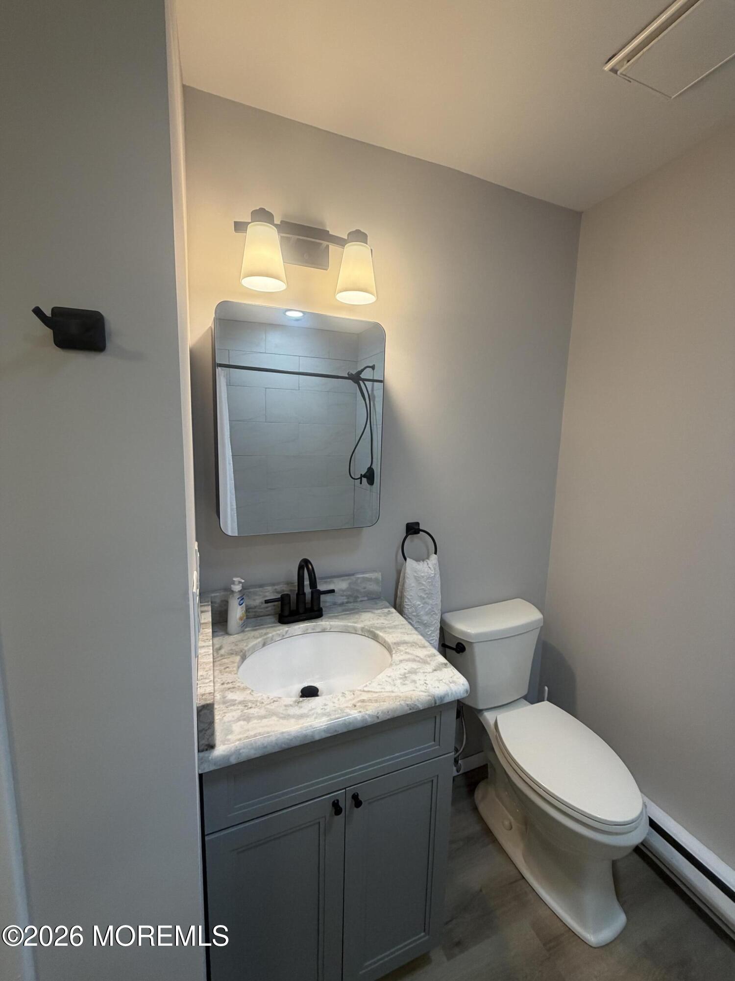 31 Homestead Drive, Unit A Whiting, NJ 08759 - Photo 19 of 23 a bathroom with a toilet a sink and mirror