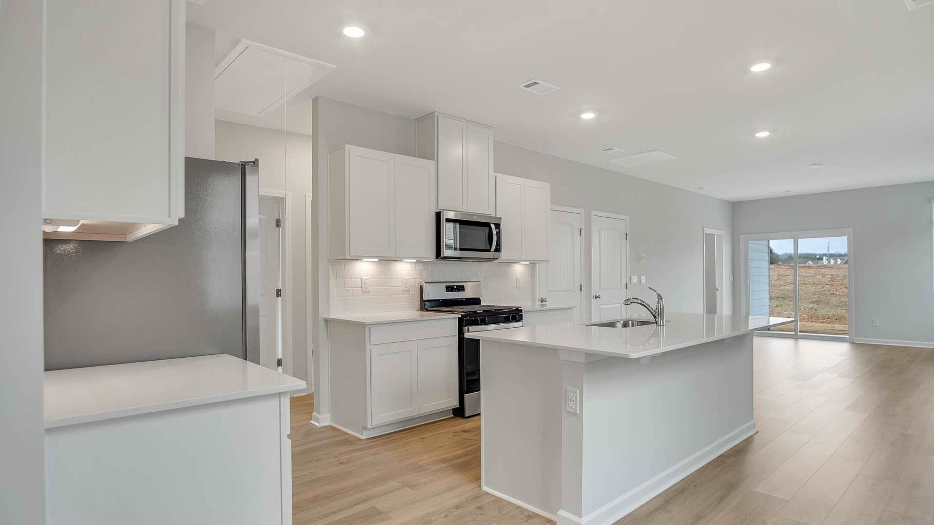 4906 Barnburgh Lane Murfreesboro, TN 37129 - Photo 4 of 11 a kitchen with stainless steel appliances granite countertop a refrigerator and a stove top oven