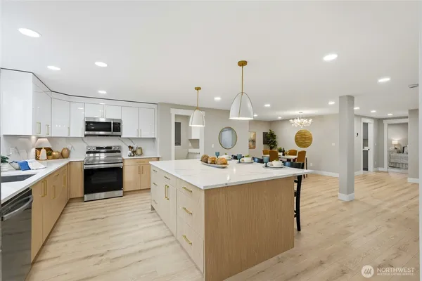 a kitchen with a stove sink and a refrigerator