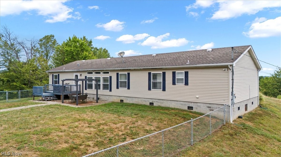 82 Patterson Ridge Road Rockport, WV 26169 - Photo 41 of 46 Rear view of house with a wooden deck and a lawn