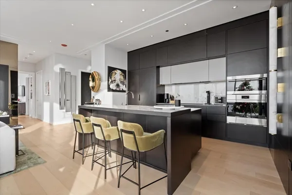 a kitchen with stainless steel appliances a sink stove and refrigerator