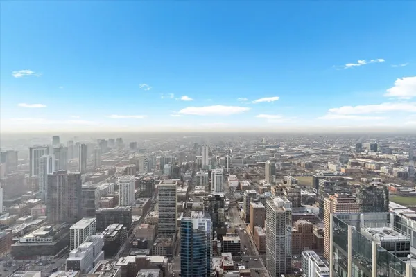 a patio with couches and a fire pit