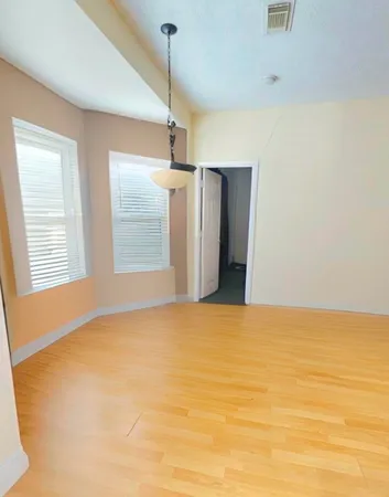 a view of a kitchen with wooden floor and a ceiling fan