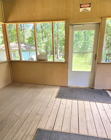 a view of a field with a tree in it