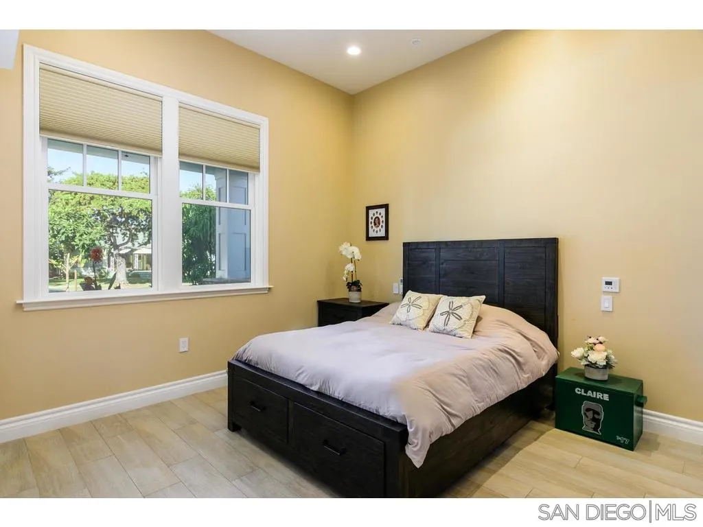 261 E Avenue Coronado, CA 92118 - Photo 18 of 25 a bedroom with a bed and a window