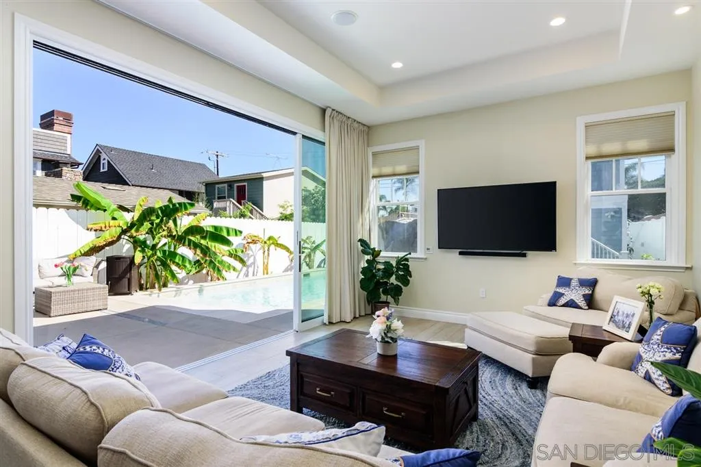 261 E Avenue Coronado, CA 92118 - Photo 9 of 25 a living room with furniture and a flat screen tv