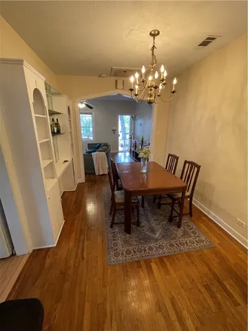 a view of a dining room with furniture and chandelier