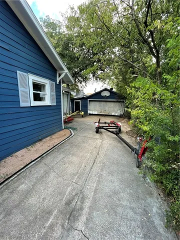 a view of a patio with table and chairs under an umbrella