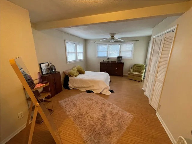 a bedroom with furniture and a window
