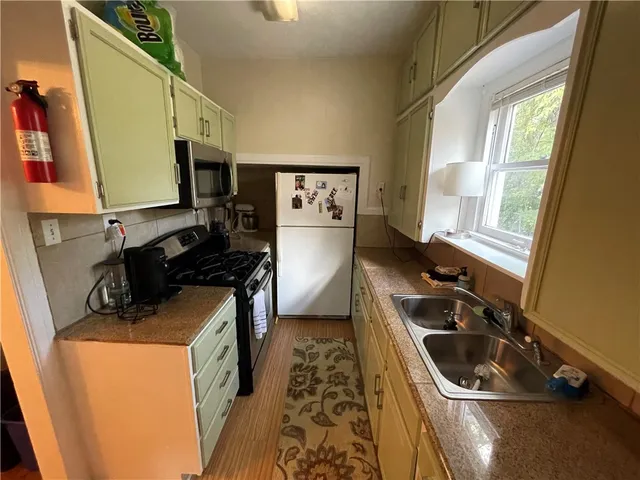 a kitchen that has a sink and a stove