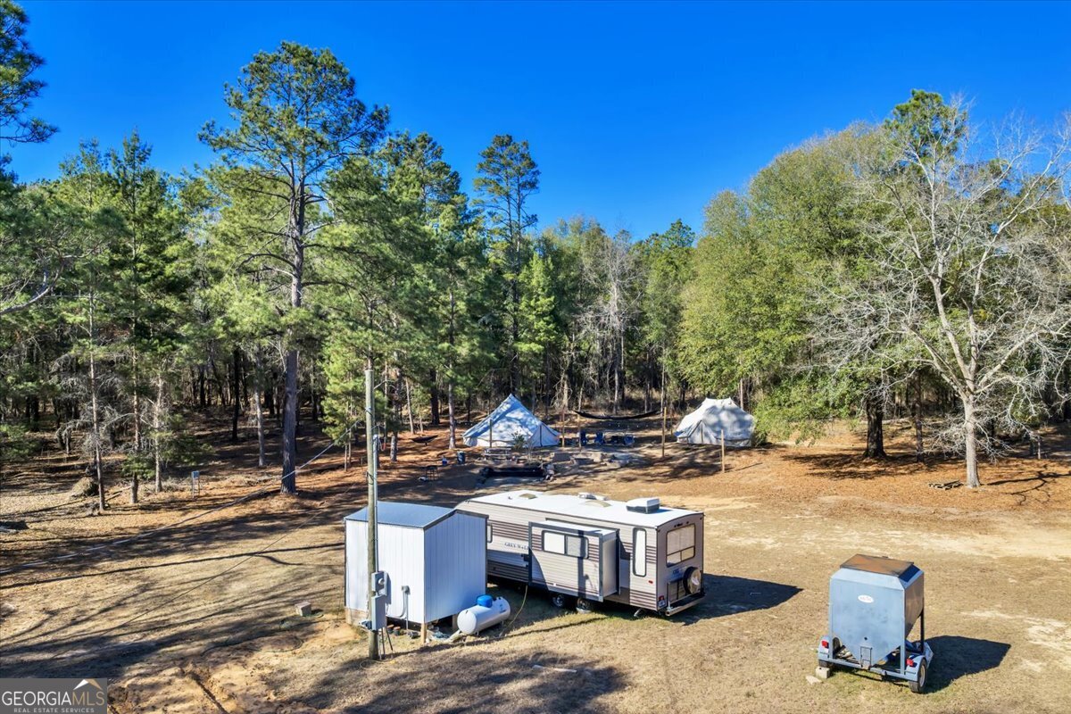 296 Boxwood Road Fort Valley, GA 31030 - Photo 42 of 52 a view of a fire pit with trees