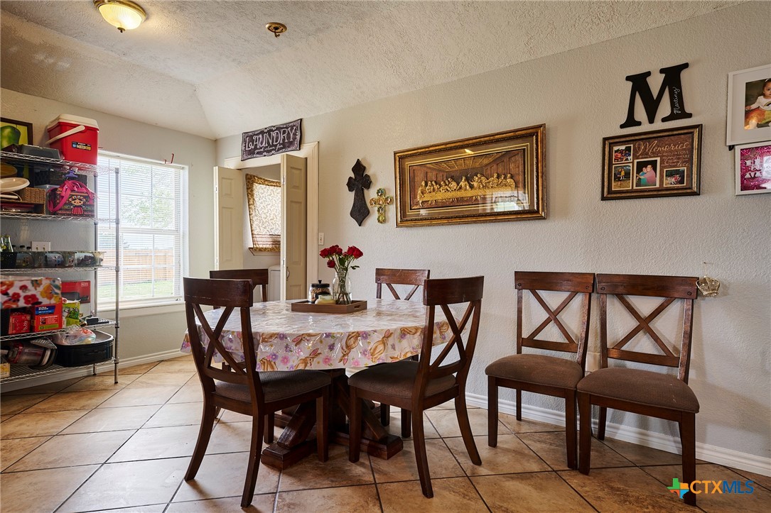 1085 Garrett Trail Maxwell, TX 78656 - Photo 11 of 40 a view of a dining room with furniture and a window