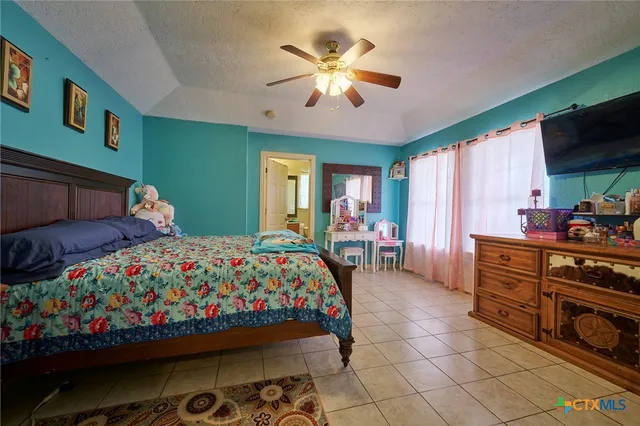 a bedroom with bed and a chandelier