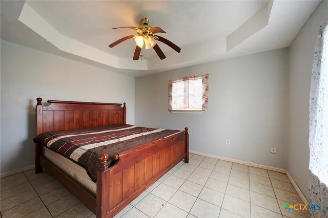 a bedroom with a bed and window
