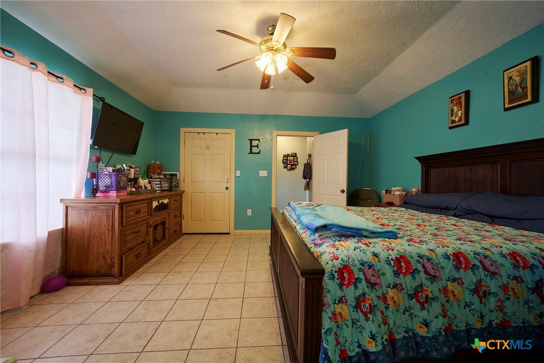 1085 Garrett Trail Maxwell, TX 78656 - Photo 21 of 40 a bed room with furniture and a flat screen tv