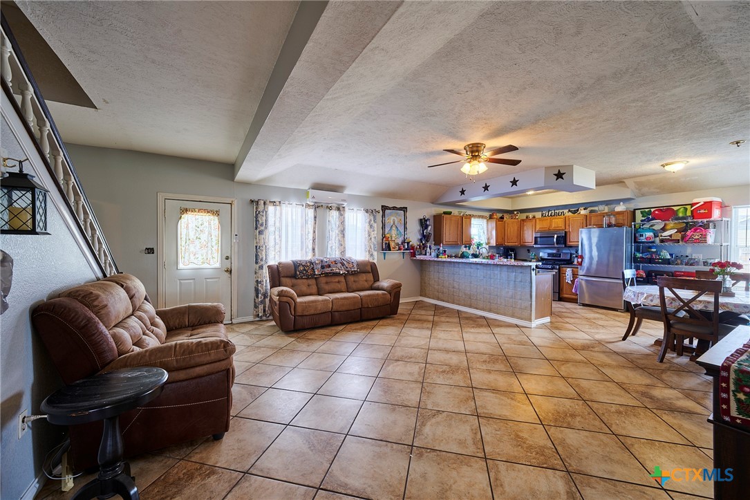 1085 Garrett Trail Maxwell, TX 78656 - Photo 9 of 40 a living room with lots of furniture and kitchen view