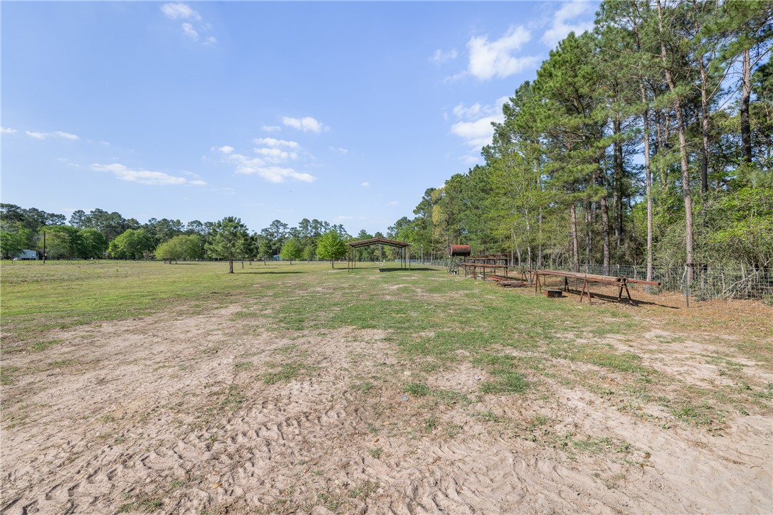 5890 Magan Road Navasota, TX 77868 - Photo 12 of 33 a view of outdoor space with deck and yard
