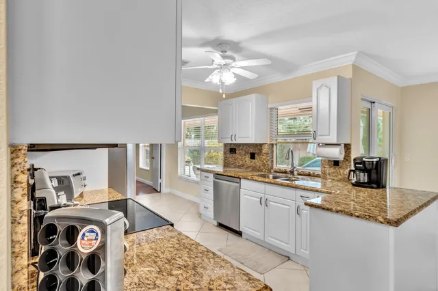 a large kitchen with kitchen island granite countertop a sink and dishwasher