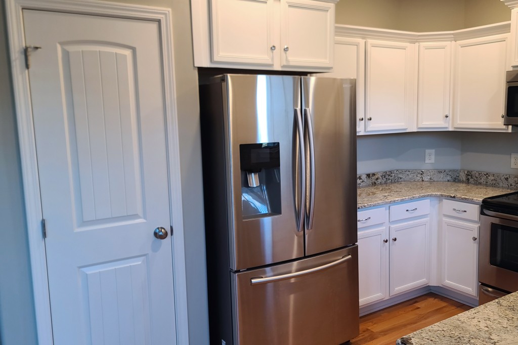 1077 Golf View Way Spring Hill, TN 37174 - Photo 8 of 32 a metallic refrigerator freezer sitting in a kitchen