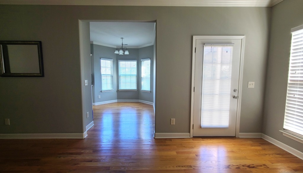 1077 Golf View Way Spring Hill, TN 37174 - Photo 10 of 32 an empty room with wooden floor and windows