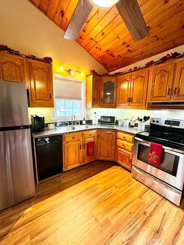a kitchen with stainless steel appliances granite countertop a stove a sink and a refrigerator