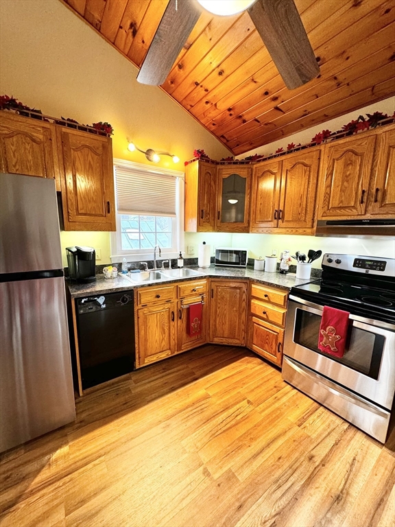 a kitchen with stainless steel appliances granite countertop a stove a sink and a refrigerator