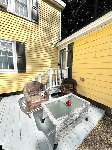 a backyard of a house with outdoor seating