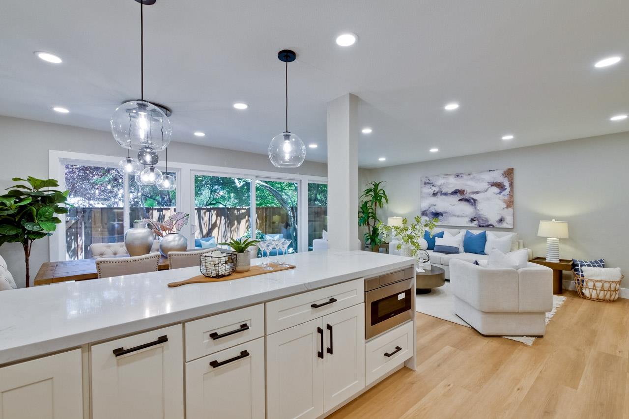 10993 Northsky Square Cupertino, CA 95014 - Photo 12 of 48 a kitchen with counter top space and a living room view