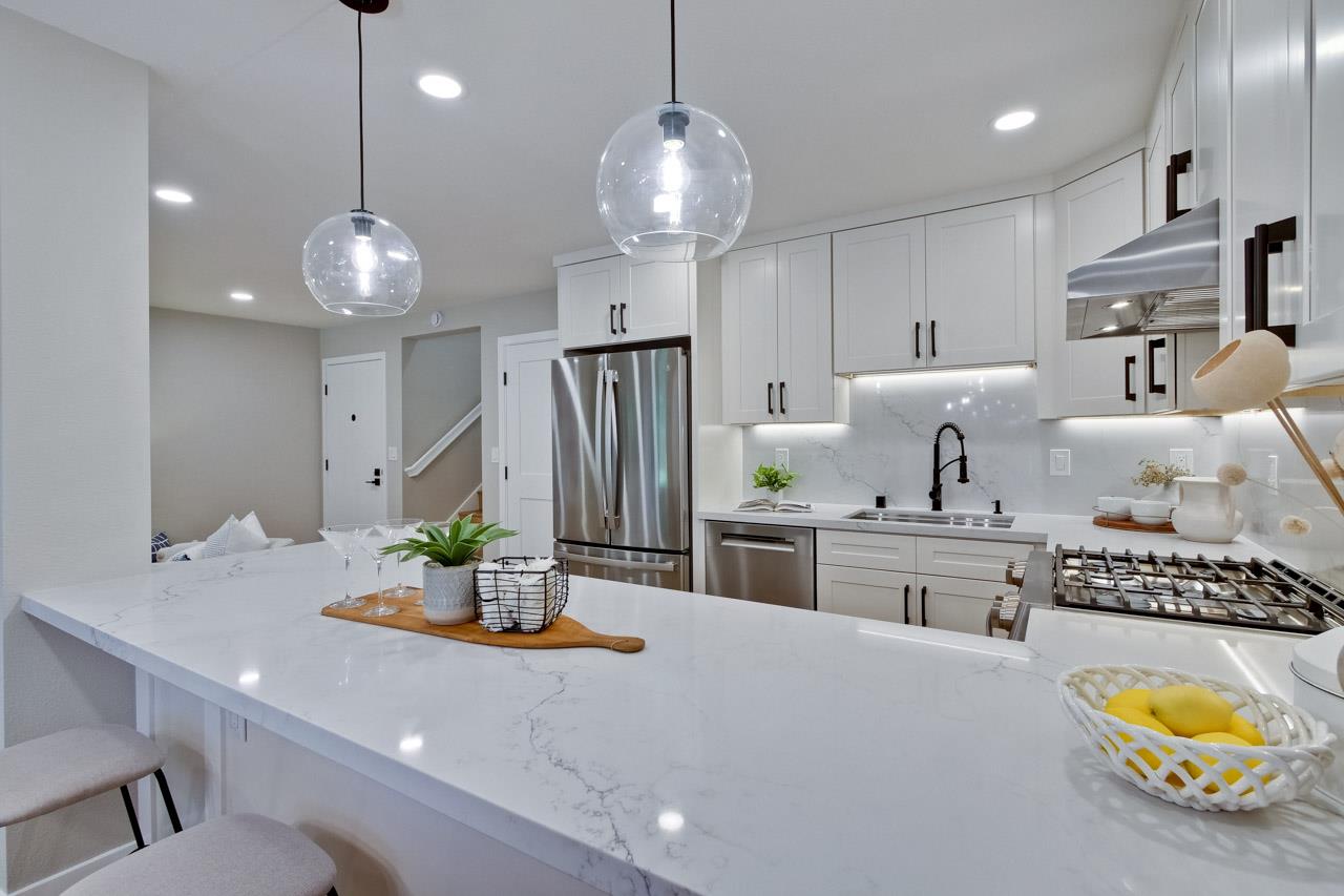 10993 Northsky Square Cupertino, CA 95014 - Photo 14 of 48 a kitchen with stainless steel appliances granite countertop a sink stove and refrigerator