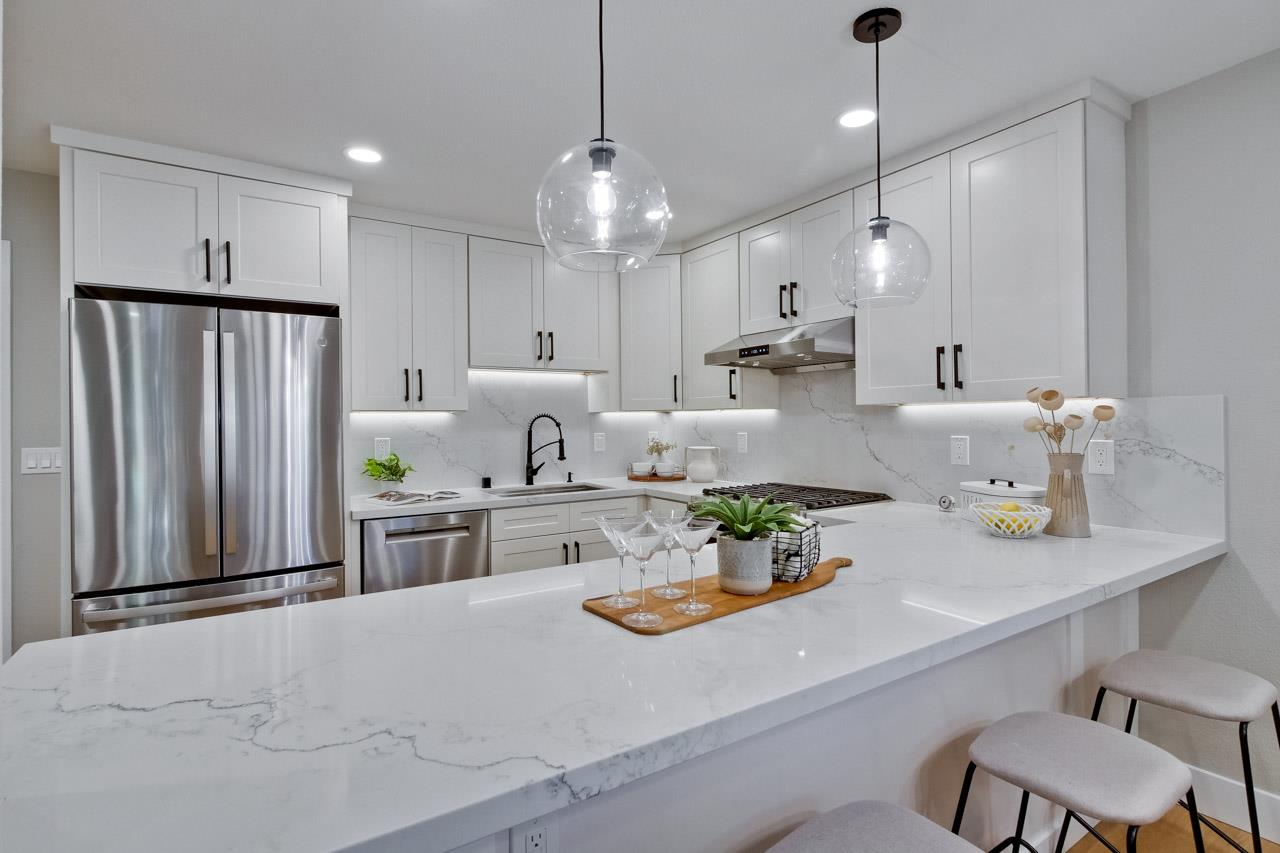 10993 Northsky Square Cupertino, CA 95014 - Photo 15 of 48 a kitchen with white cabinets and refrigerator