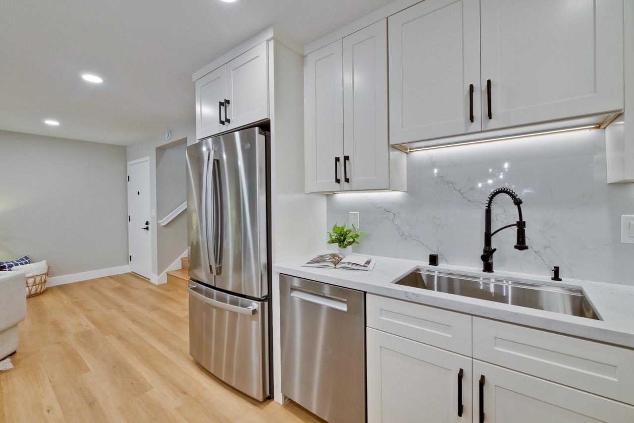 10993 Northsky Square Cupertino, CA 95014 - Photo 16 of 48 a kitchen with stainless steel appliances a refrigerator sink and cabinets