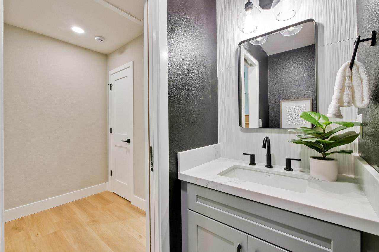 10993 Northsky Square Cupertino, CA 95014 - Photo 20 of 48 a bathroom with a sink a potted plant and a mirror