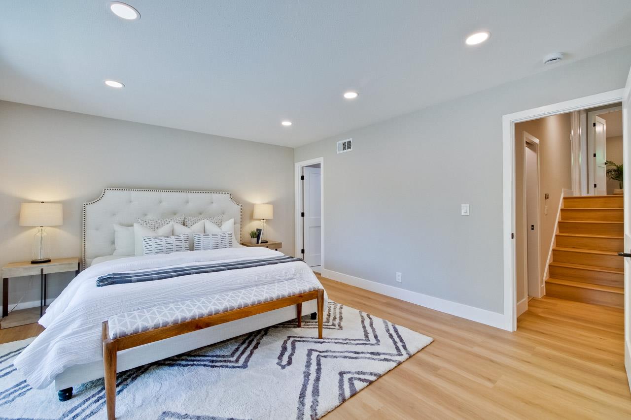 10993 Northsky Square Cupertino, CA 95014 - Photo 23 of 48 a bedroom with a bed and wooden floor