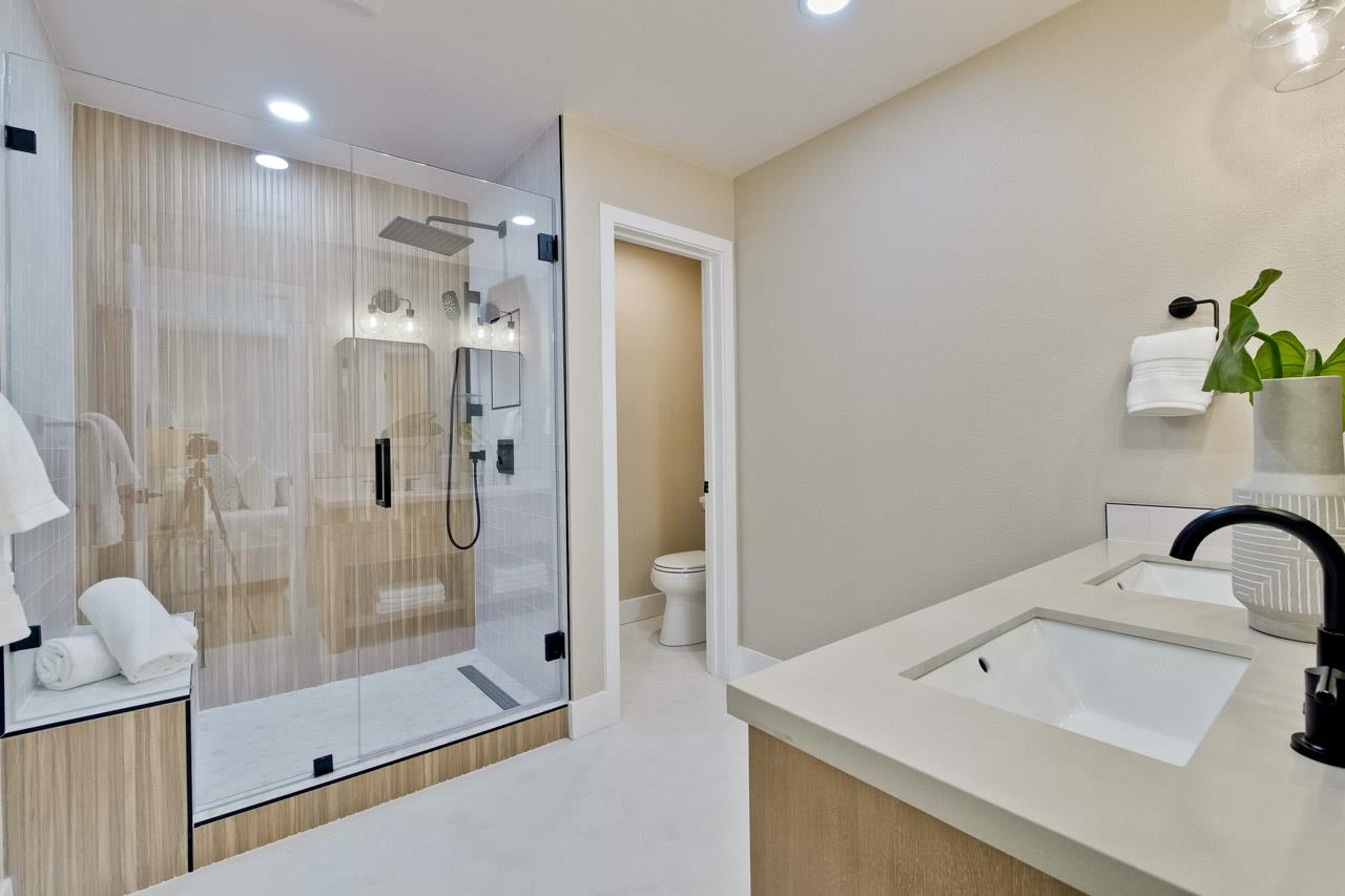10993 Northsky Square Cupertino, CA 95014 - Photo 24 of 48 a bathroom with a shower sink and mirror