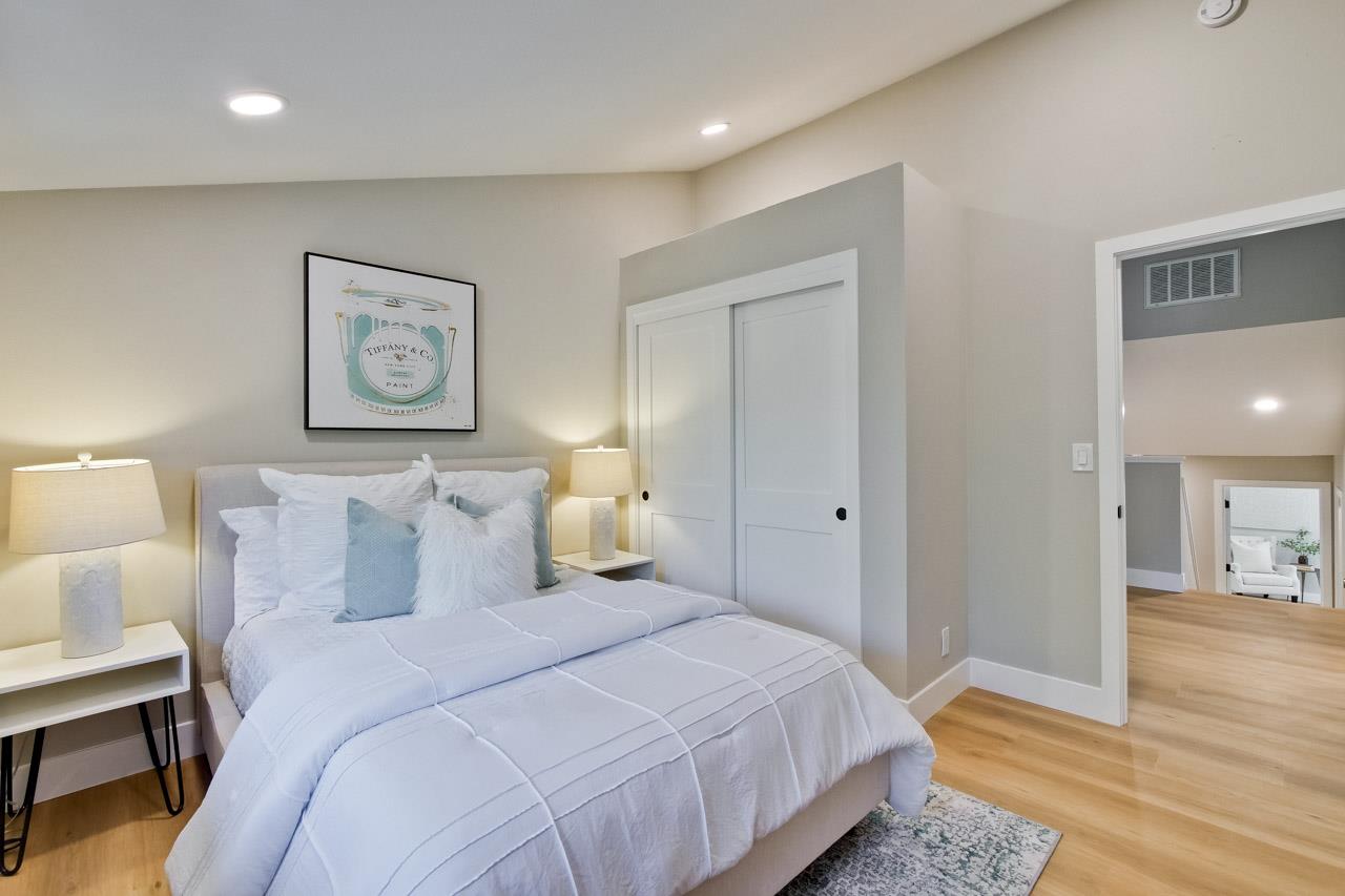 10993 Northsky Square Cupertino, CA 95014 - Photo 31 of 48 a bedroom with a bed and a lamp