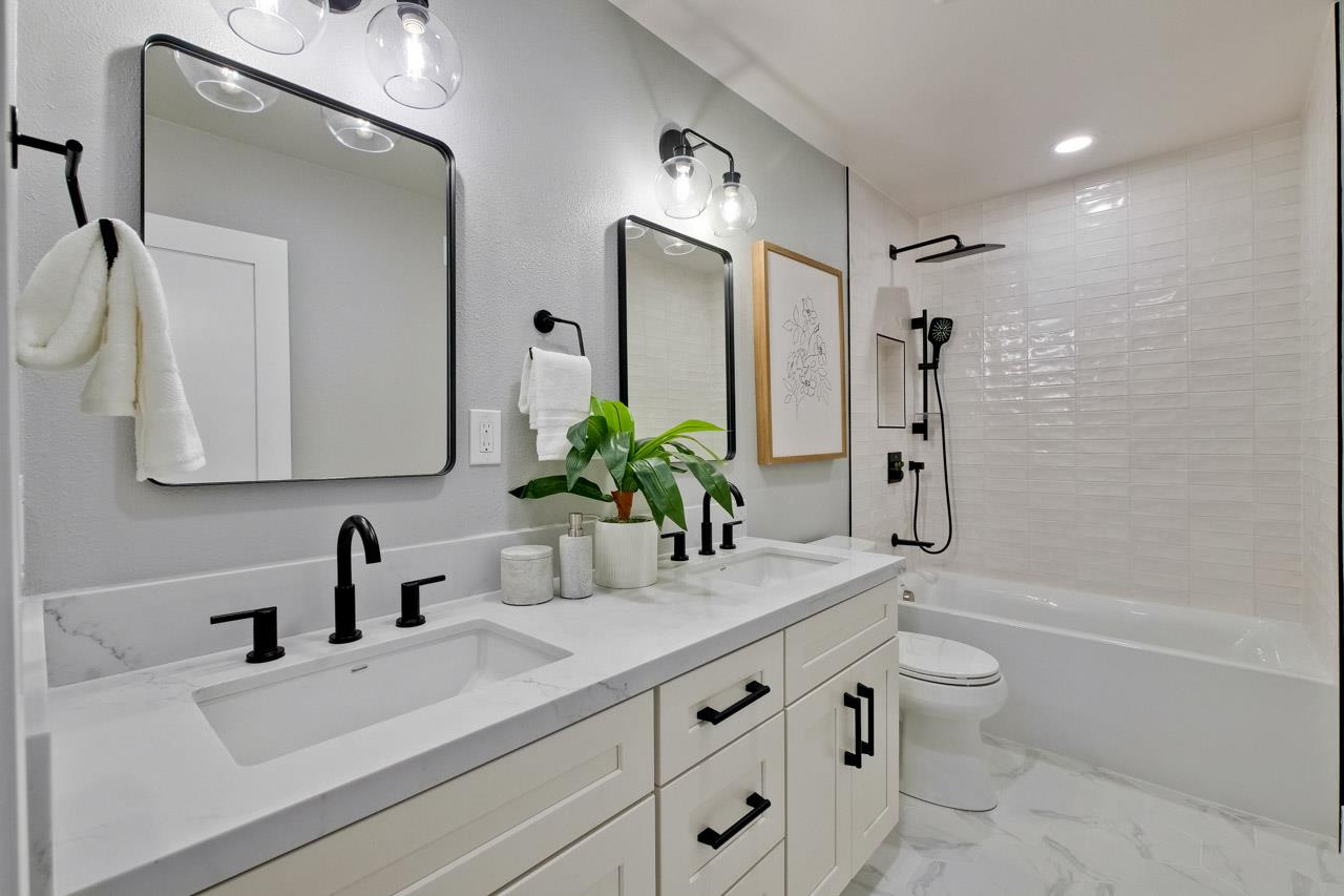10993 Northsky Square Cupertino, CA 95014 - Photo 32 of 48 a bathroom with a sink a toilet and a large mirror