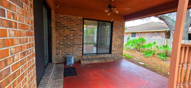 a view of a porch with a floor to ceiling window with wooden floor