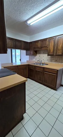a kitchen with stainless steel appliances a sink and a stove
